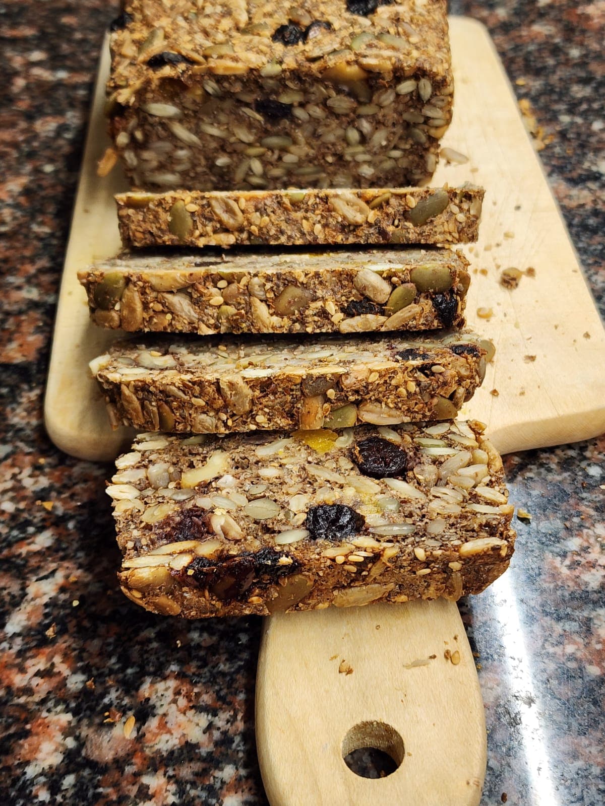 SeedSymmetry gluten-free seeded loaf slices on a cutting board